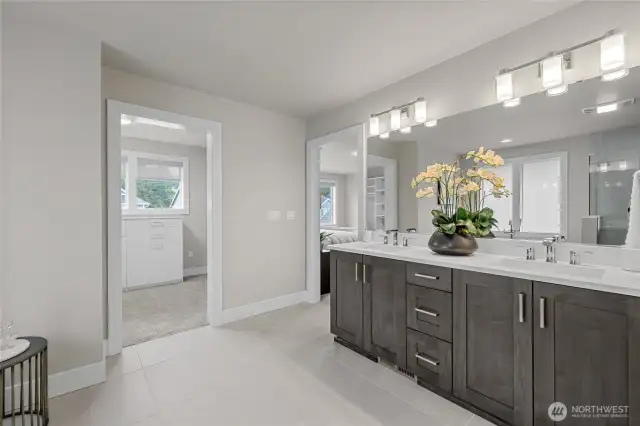 Dual vanities and access to a custom walk-in closet.