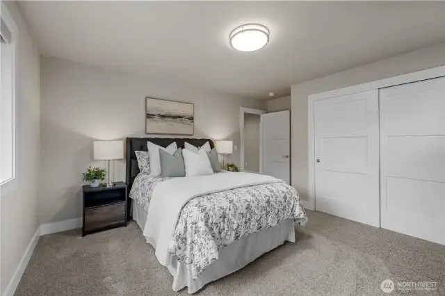 Third bedroom with custom built-in closet drawers and shelving.