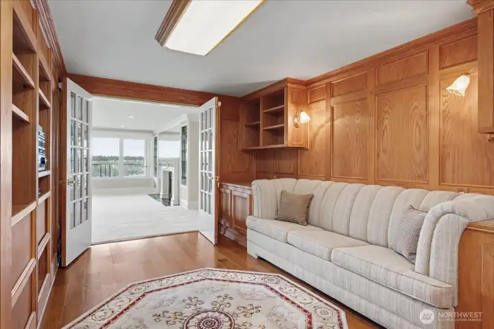 Rich wood paneling adds character, charm and a cozy lodge-like feel to this room doing double duty as a guest room with custom built sofa bed, office setup and TV/Sound system included.  Notice the 15-paned doors throughout the condo, all with Hunter Douglas shades.