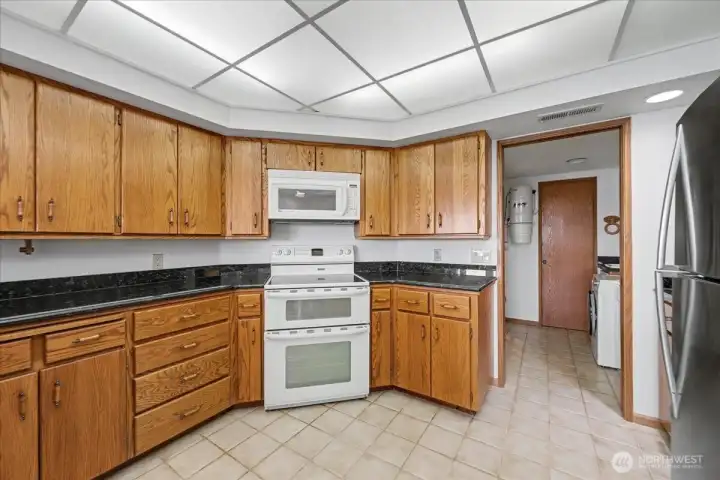 Abundant cabinetry with rolling shelves for storage convenience.