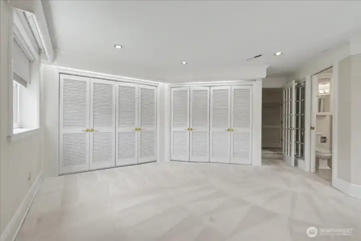 The primary bedroom features louvered doors, well-lit cedar-lined closets, room darkening shades and a king-size space for your furniture arrangement.
