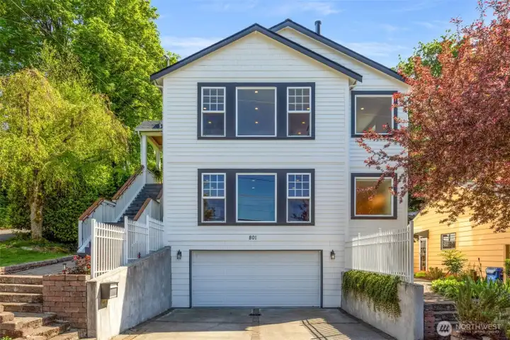 This home has great street presence on a corner lot surrounded by greenery.  The rare 2 car garage is complemented by a driveway with off street parking for 2 more cars!