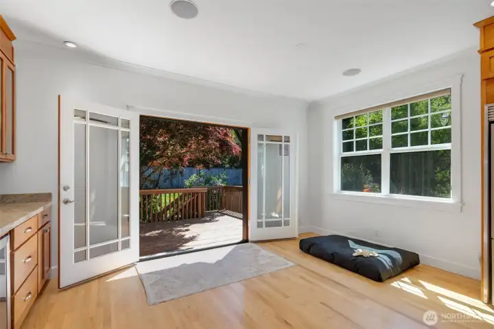 Double-doors open to the back deck and backyard greenery!