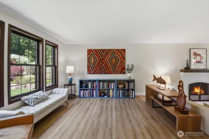 Sitting room with large windows letting in natural light, low maintenance laminate flooring. Sitting room with large windows letting in natural light, low maintenance laminate flooring.