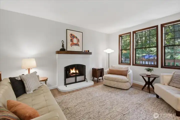 Wood burning fireplace, laminate flooring with nice natural light. Wood burning fireplace, laminate flooring with nice natural light.