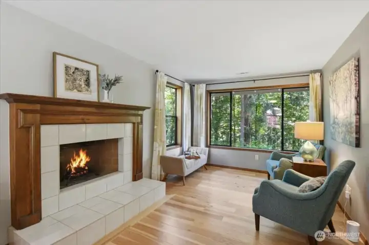 Primary bedroom with wood burning fireplace and lovely views of the greenbelt and backyard. Primary bedroom with wood burning fireplace and lovely views of the greenbelt and backyard.