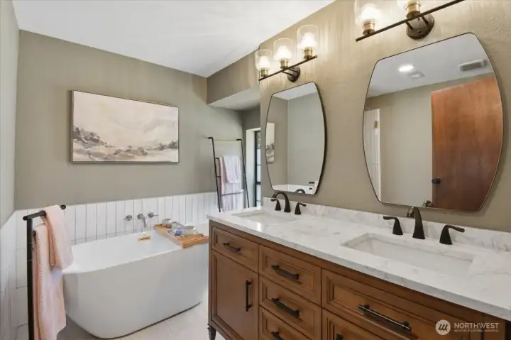 Primary bathroom with soaking tub and double sink vanity. Primary bathroom with soaking tub and double sink vanity.