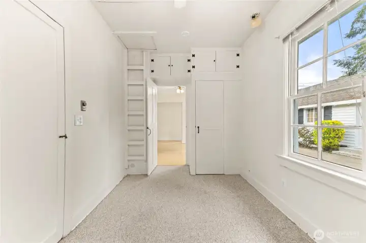 Bedroom 1 off kitchen with built-in storage