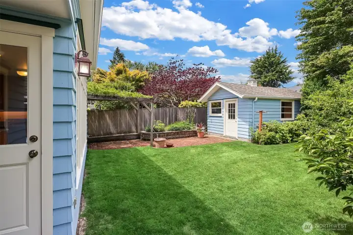 Step out from the kitchen into the remarkably peaceful, fully fenced backyard that feels like a private retreat, with fruit trees and generous space to relax, entertain, garden, and enjoy the outdoors