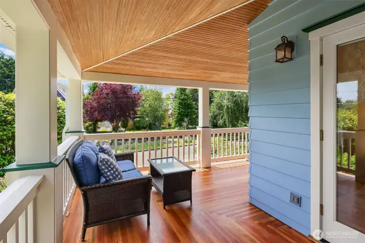 Covered wraparound front porch with refinished hardwood oak floors overlooking, perfect for year round relaxation