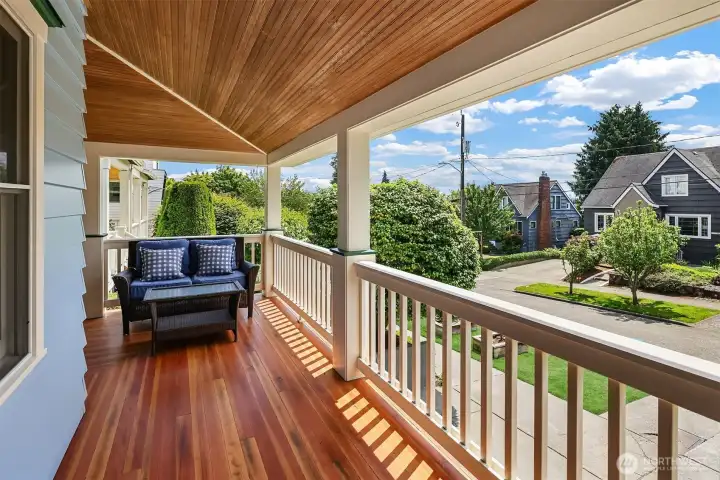 Covered wraparound front porch with refinished hardwood oak floors overlooking, perfect for year round relaxation