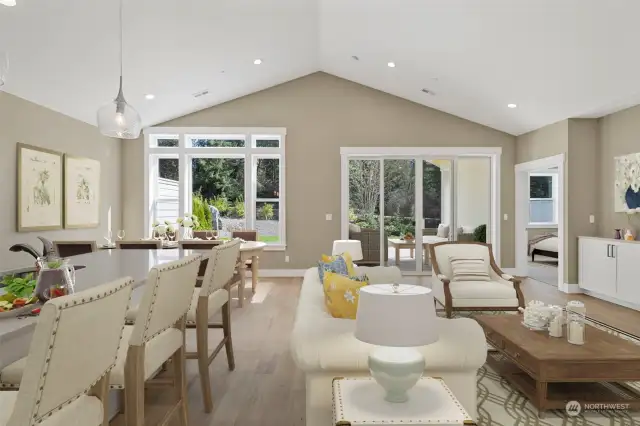 Great room with vaulted ceiling, engineered plank flooring and wide millwork throughout. This home is virtually staged.