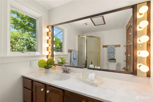 A short hallway extends from the kitchen to the main floor 3/4 bath on the left with a window to the back yard. Bathrooms are in working order, but ready for updates to your taste. A built-in linen closet offers storage just outside in the hall.