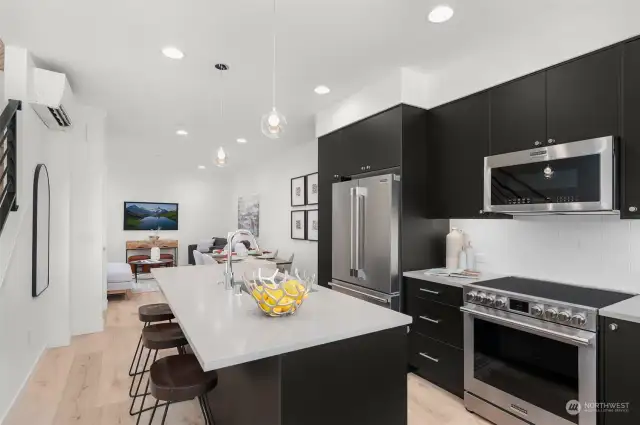 Your culinary haven extends into an open-concept layout, showcasing timeless finishes and vibrant energy. This kitchen inspires creativity, connection, and memorable gatherings.