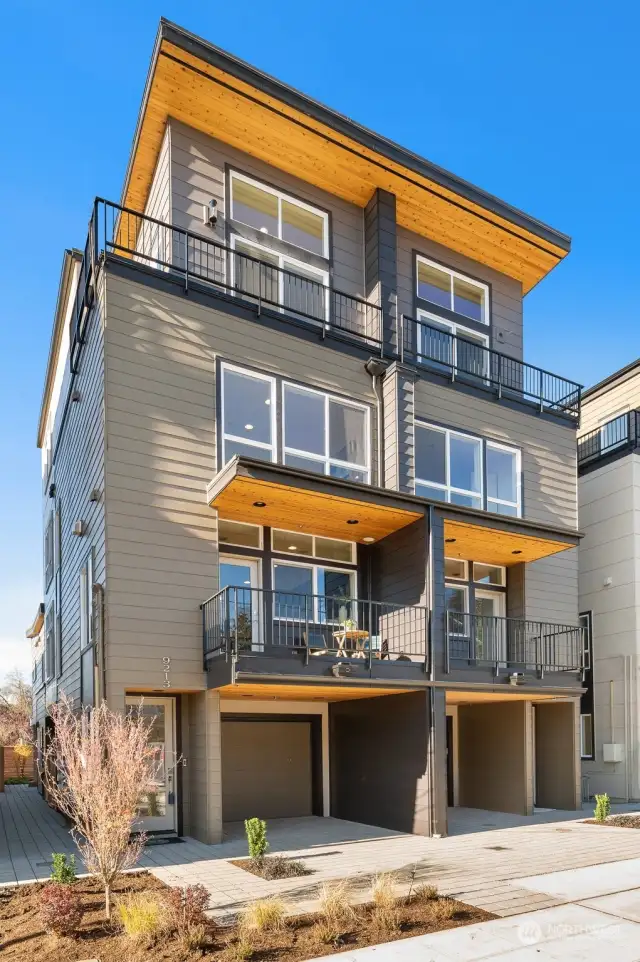 Discover timeless elegance in this thoughtfully designed home. Enjoy the seamless indoor-outdoor connection with balconies and large windows framing every floor. Imagine yourself relaxing in this contemporary sanctuary.