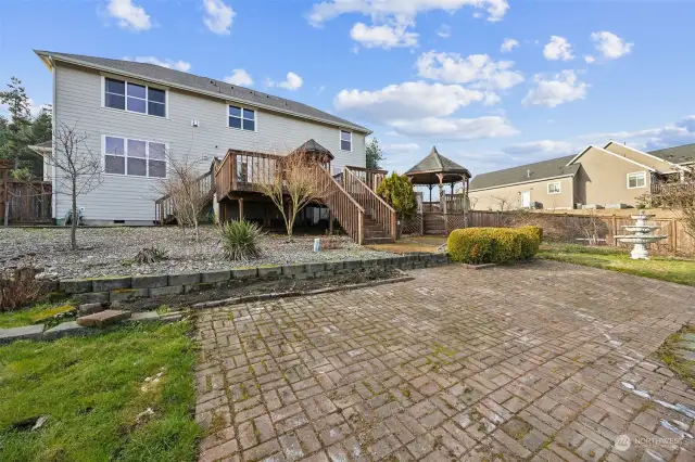 Large deck and back yard with grow boxes and friut trees