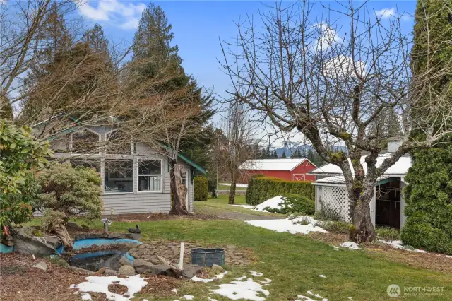 View of the West side of the home with what used to be a koi pond and the outbuilding