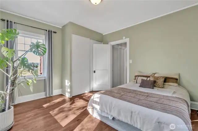 This bedroom has windows facing four directions