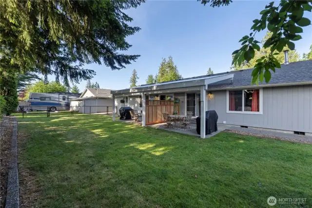 Two outbuildings, one thoughtfully designed as additional living quarters and the other as a garden shed.