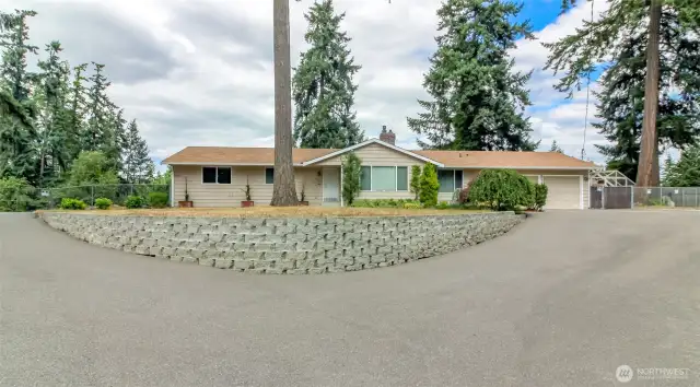 Drive to the right goes to the front door- to the left goes to the detached garage.