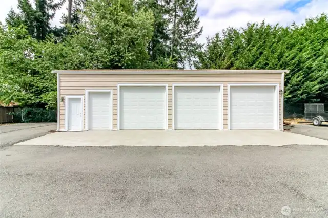 Man door with lawnmower door and three bays… huge garage can fit 6 cars