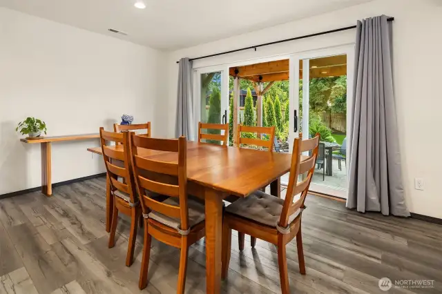 Dining room featuring upgraded glass paneled sliding doors leading to outdoor patio.