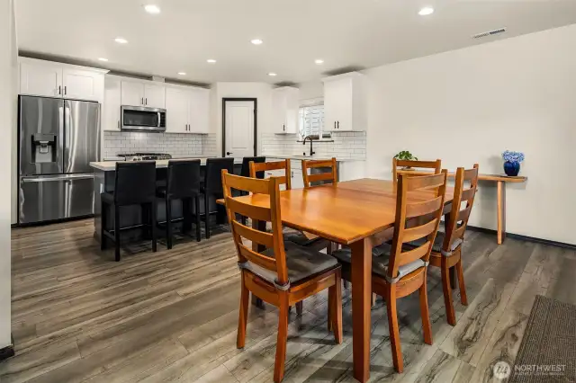 Open concept dining room flowing into kitchen.