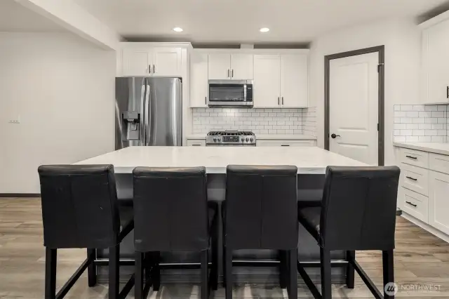 Large kitchen with ample counter space & cabinet storage.