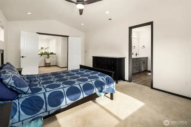 Primary bedroom with french doors and ensuite bathroom.