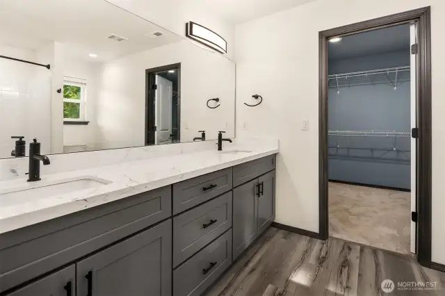 Ensuite bathroom with double vanity sinks and large walk-in closet.