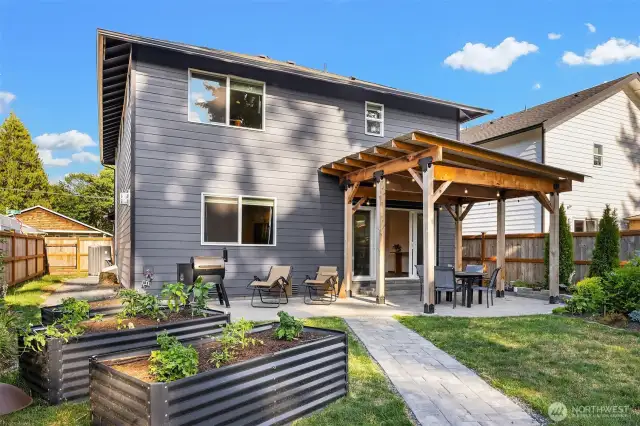 Serene garden space & covered patio in backyard.