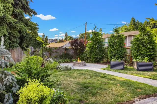 Fire pit area in back yard, perfect for relaxing or entertainment.