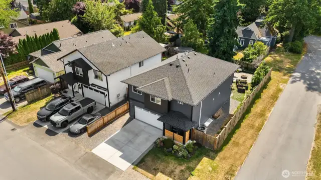 Bright, corner lot with gravel pad in front of the home for additional parking.