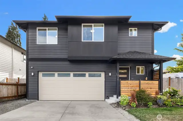 Spacious driveway, two car garage, and covered front porch.