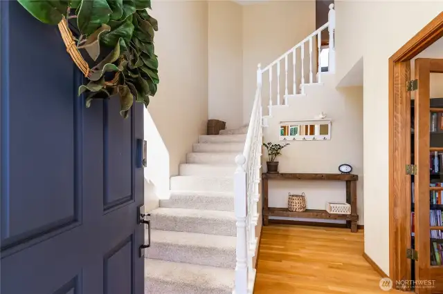 As you enter the home, you have tall ceiling and stairs leading to 3 bedrooms upstairs