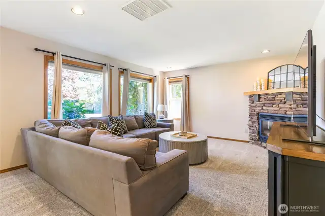 Living room across from the kitchen. Gas fireplace and windows create a great atmosphere to spend time