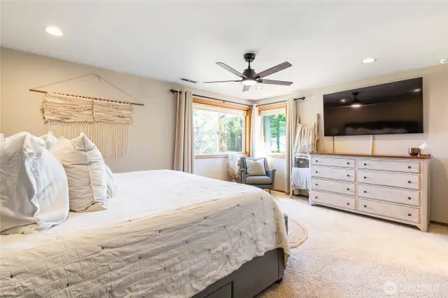 Primary bedroom, looks to the back yard and view of Mt Baker