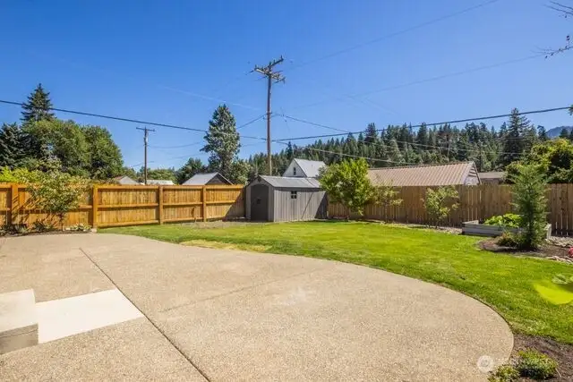 Large fenced backyard with sprinkler system
