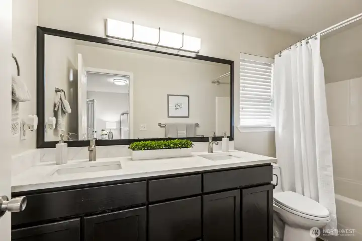 Primary en-suite with new sinks, faucets, mirror, lighting and quartz counters