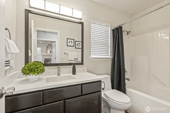 Upstairs bathroom with new sink, faucet, mirror, lighting and quartz counters