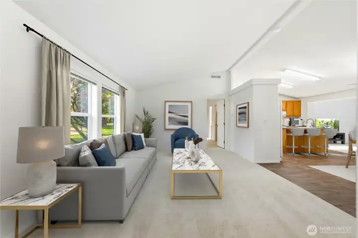 Step into a bright formal living room filled with natural light from oversized windows.