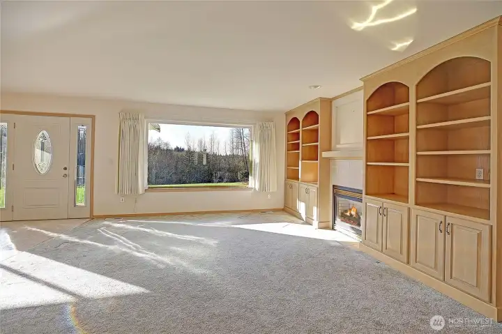 Custom built-in book shelves surround the gas fireplace in the living room.