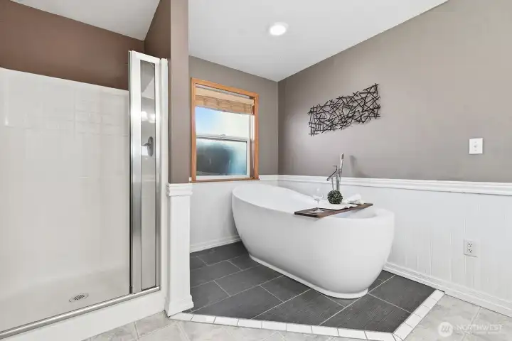 Primary bathroom with soaking tub and shower.