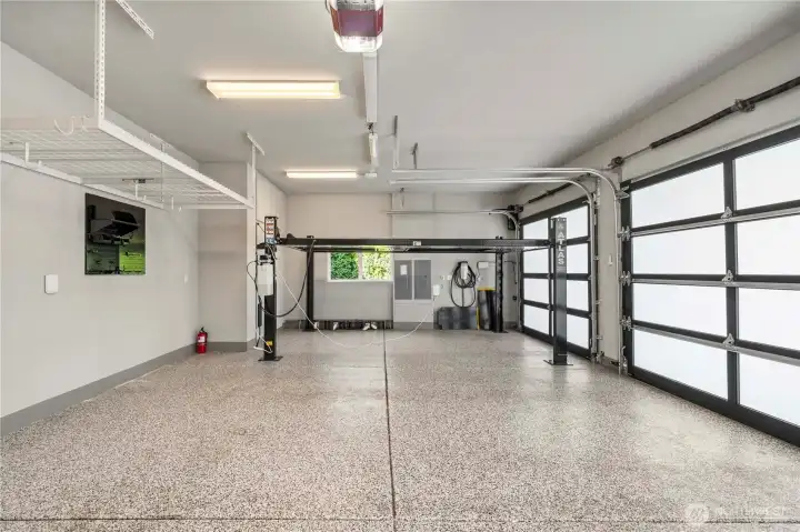 Spacious 3-car garage equipped with an auto lift and Tesla charger