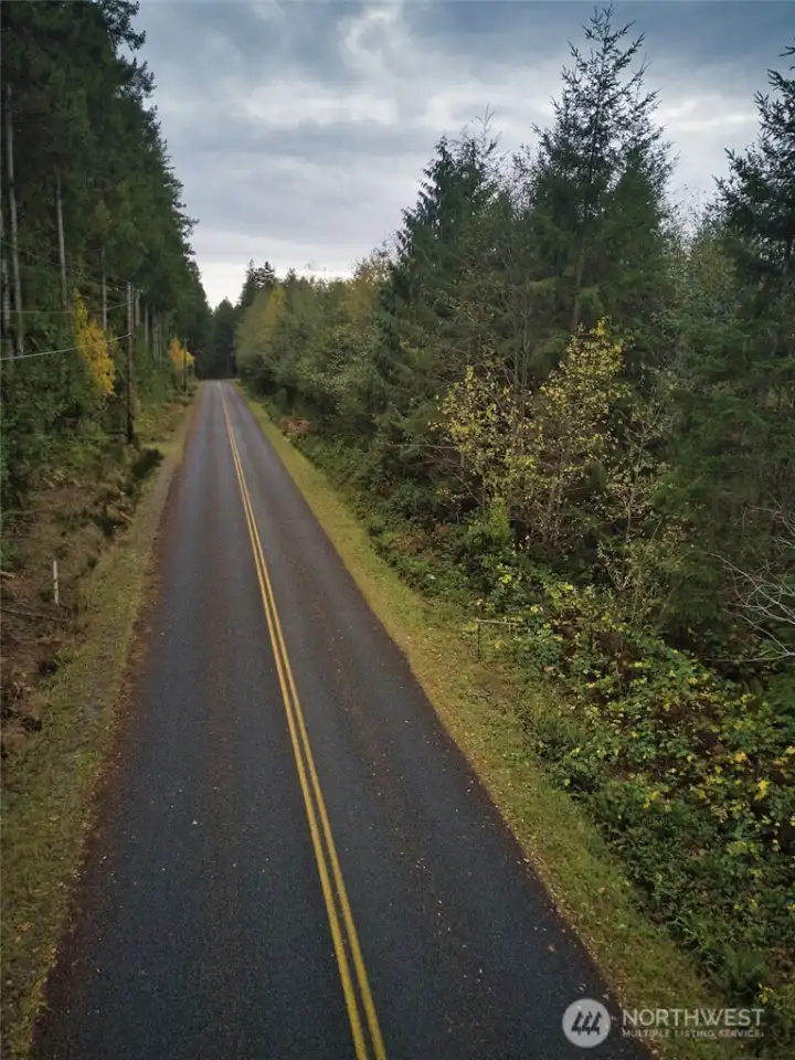 No homes in site. This view is to the North with the property on the left side of the road.