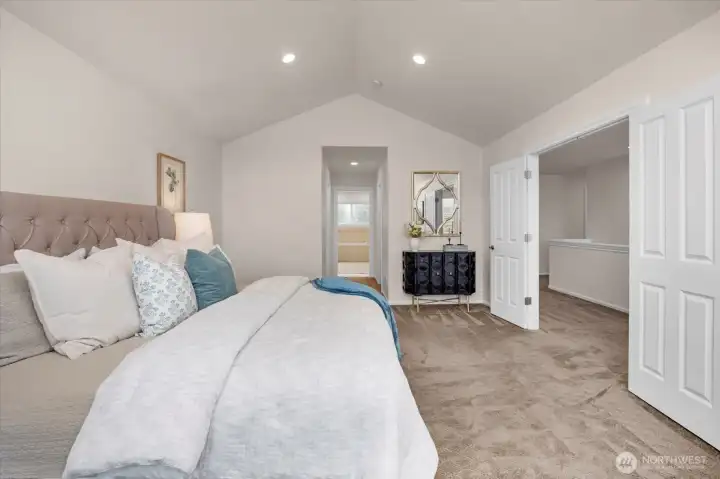 The primary flows into the dual walk-in closets and then to the spacious bathroom.