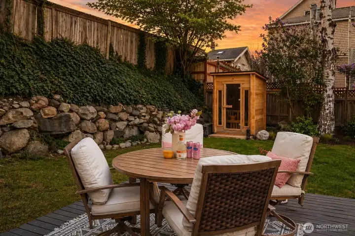 Your outdoor life just got a major upgrade.  Privacy and light in the level yard with party sized deck, lawn garden beds, and sauna.