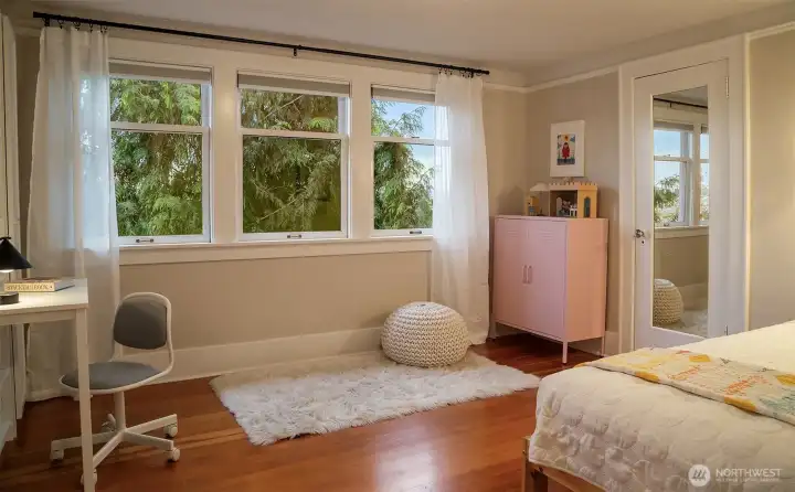 The second upstairs bedroom has a walk in closet and gleaming fir floors.