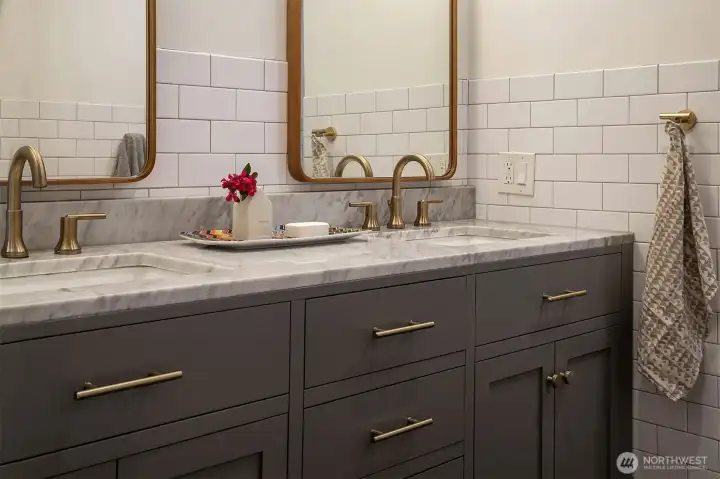 Upstairs bath with marble countertops.