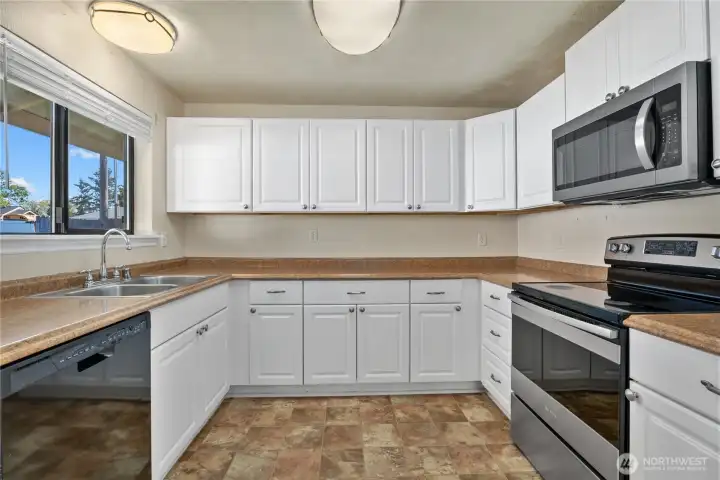 Large updated kitchen with stainless steel appliances.